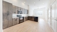 This compact yet well-designed apartment in Austin, TX offers 540 square feet of living space on a single floor. The property features one bedroom measuring 140 square feet and one bathroom, making it an ideal space for a single occupant or couple.

The kitchen is a standout feature, boasting modern amenities and ample storage. It's equipped with sleek, dark-colored appliances including a refrigerator, oven, and microwave. The L-shaped layout maximizes space efficiency, with gray cabinets providing a contemporary aesthetic. A white backsplash and light hardwood floors create a bright, open feel.

The bathroom showcases a long vanity with a marble-like countertop, offering plenty of storage and counter space. A large mirror spans the length of the vanity, enhancing the sense of space.

The bedroom, while compact, benefits from natural light through a sizable window with horizontal blinds. The hardwood flooring continues into this space, maintaining a cohesive look throughout the apartment.

Throughout the property, white walls and ceilings contribute to a clean, modern aesthetic. The hardwood floors add warmth and character to the space. Large windows in the living areas and bedroom allow for ample natural light, creating a bright and inviting atmosphere.

Despite its modest size, this apartment efficiently utilizes every square foot, resulting in a functional and comfortable living space in the heart of Austin.