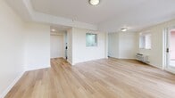 Located at 685 West Broadway in Monticello, NY, this well-designed two-bedroom, two-bathroom residence offers a thoughtfully organized single-floor layout with a clean, modern aesthetic throughout. Light-toned hardwood flooring runs through the living areas and bedrooms, complementing the bright, neutral color palette that gives the space an open and airy feel.

The galley-style kitchen is efficiently laid out with white cabinetry, dark countertops, stainless steel appliances including an electric range and dishwasher, and a sleek tile floor — offering both style and functionality. The combined dining and living area is generously proportioned, featuring multiple windows and a door leading directly to a private patio, filling the space with natural light and providing easy outdoor access.

The spacious primary bedroom includes a walk-in closet with wire shelving systems and views to the outside. The second bedroom also benefits from natural light through its window and offers a built-in closet. Both bedrooms feature the same warm hardwood flooring found throughout.

One bathroom stands out with a corner soaking tub, mosaic tile flooring, and large-format wall tiles, creating a refined, spa-like atmosphere. A dedicated laundry area and five total closets round out this well-equipped and storage-rich residence.