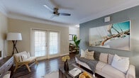 Located at 325 Marymeade Dr in Summerville, SC, this well-appointed single-story home offers three bedrooms and two bathrooms within a comfortable and efficiently designed layout. Dark hardwood-style flooring flows throughout the main living areas, complemented by neutral warm-toned walls and crisp white crown molding that adds a polished, classic character throughout.

The open kitchen features white cabinetry, a tiled backsplash, granite countertops, stainless steel appliances, and a breakfast bar peninsula that connects seamlessly to the dining and living areas. The dining room is accented by a stylish pendant light and a tray rail on the walls, adding architectural detail. The living room is bright and inviting, with French doors that allow abundant natural light, a ceiling fan, and a distinctive slate-blue accent wall.

The primary bedroom offers plush carpeting, a ceiling fan, a dedicated closet, and direct access to an adjoining room ideal for a home office. Additional bedrooms also feature carpet, ceiling fans, and natural light from large windows with blinds. The bathrooms are clean and functional, with one featuring a full tub-shower combination. A dedicated laundry room accommodates full-size washer and dryer units with overhead shelving for added storage.