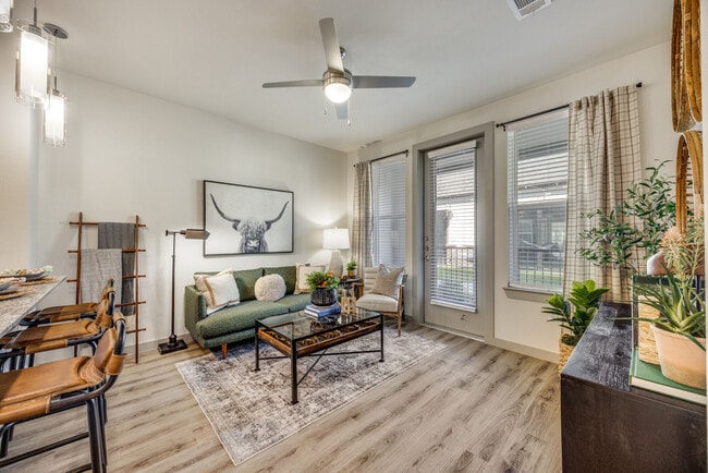 Living room with ceiling fan and natural light - Aspire at Greenville