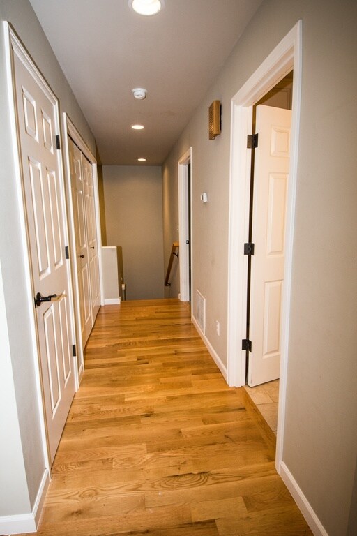 Hallway to main floor bedroom, laudry room, bathroom, and stairs to Work Space or Rec Room and garage. - 3005 30th Ave W