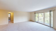 Located at 24 Heritage Cir, Unit 8 in Madison, WI, this 2-bedroom, 1-bathroom residence offers a well-organized single-floor layout with a comfortable and functional design throughout. The spacious living room is carpeted and filled with natural light, featuring sliding glass doors that open onto a private balcony overlooking a lush, tree-lined landscape — an inviting outdoor extension of the living space. A second living area connects seamlessly to the entry and kitchen, providing versatile use of the open floor plan. The kitchen is efficiently designed in an L-shaped configuration, showcasing warm oak cabinetry with brass hardware, white countertops, light hardwood flooring, and a full suite of stainless steel appliances including a refrigerator, range, over-the-range microwave, and dishwasher. The generously sized primary bedroom features plush carpeting, ample closet space with sliding wood doors, and multiple windows that invite in natural light and views of the surrounding greenery. The full bathroom is finished with clean white subway tile surrounding a tub/shower combo and chrome fixtures. A connecting hallway ties all spaces together, creating a cohesive and practical flow throughout this well-appointed Madison home.