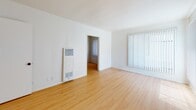 Located at 729 Gayley Ave in the Westwood neighborhood of Los Angeles, Unit 200 is a well-appointed single-floor residence that combines clean, modern finishes with functional design. Warm hardwood-style flooring extends throughout the living spaces, creating a cohesive and inviting atmosphere. The living room is generously sized, featuring large windows dressed with vertical blinds that allow abundant natural light to fill the space, along with views of surrounding greenery. A ceiling fan adds both comfort and character to the bedroom, which also benefits from window access and a built-in closet with ample storage. The galley-style kitchen is a standout feature, showcasing vibrant teal subway tile backsplash that provides a striking contrast against crisp white cabinetry and countertops. It is equipped with a gas range, refrigerator, and a double-basin sink, making it both practical and visually engaging. A wall-mounted heating unit is present in the living area, providing efficient climate control. The bathroom is clean and functional, featuring a tub-shower combination with a sliding glass enclosure. The overall ambiance of the unit is light, airy, and neutral, offering a versatile canvas well-suited to a variety of interior styles. Its prime Westwood location places residents near UCLA, shopping, dining, and major transit corridors.