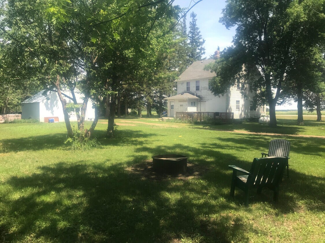 Firepit view of yard, house and garage - 305 4th St