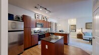Located at 90 Molina Way in Saint Charles, Missouri, this single-story, three-bedroom, two-bathroom home offers a thoughtfully arranged floor plan that maximizes every square foot. The open-concept kitchen is a standout feature, showcasing rich wood cabinetry, dark granite countertops, stainless steel appliances including a range, microwave, and refrigerator, and a peninsula with a double sink that opens toward the main living area. Hardwood-style flooring runs throughout the kitchen, transitioning to plush carpet in the living and bedroom areas. The living room is bright and welcoming, benefiting from large sliding glass doors that allow natural light to fill the space and provide views to the outdoors. The primary bedroom offers a comfortable footprint with soft carpet, a sliding double-door closet, and a calm, neutral palette. Additional bedrooms are similarly appointed with carpet and generous wall space. A walk-in closet with built-in shelving provides ample storage. The two bathrooms differ in configuration — one features a full tub-shower combination with tile flooring and a wood-toned vanity, while the second includes a framed glass-door shower stall. Together, these spaces create a functional and cohesive home well-suited for everyday living.