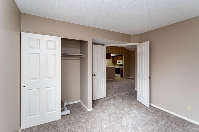 Building Photo - Cozy 2-Bed Condo with Fireplace, Garage & Pool Access Near Shopping!