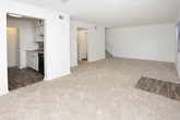 This two-story residence offers a well-organized layout across two levels, providing comfortable separation between living and sleeping areas. The main floor features a carpeted living room with natural light from a front-facing window and a sliding glass door fitted with vertical blinds, offering easy access to the outdoors. A staircase connects the lower level to the upper floor. The galley-style kitchen is equipped with white cabinetry, light granite-style countertops, a stainless steel sink, wood-look flooring, a tile backsplash, and black appliances including a refrigerator and range. A half bathroom is conveniently located on the main level.

Upstairs, two bedrooms each feature plush carpeting, ceiling fans with light fixtures, textured ceilings, and windows that bring in natural light. Both bedrooms include built-in closets with louvered bifold doors and shelving for organized storage. The full bathroom on this level features wood-look flooring, a white vanity with a light countertop, and a shower-tub combination. A dedicated linen closet provides additional storage near the upper-level bathroom, completing the home's practical and straightforward design.