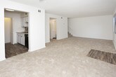 This two-story residence offers a well-organized layout across two levels, providing comfortable separation between living and sleeping areas. The main floor features a carpeted living room with natural light from a front-facing window and a sliding glass door fitted with vertical blinds, offering easy access to the outdoors. A staircase connects the lower level to the upper floor. The galley-style kitchen is equipped with white cabinetry, light granite-style countertops, a stainless steel sink, wood-look flooring, a tile backsplash, and black appliances including a refrigerator and range. A half bathroom is conveniently located on the main level.

Upstairs, two bedrooms each feature plush carpeting, ceiling fans with light fixtures, textured ceilings, and windows that bring in natural light. Both bedrooms include built-in closets with louvered bifold doors and shelving for organized storage. The full bathroom on this level features wood-look flooring, a white vanity with a light countertop, and a shower-tub combination. A dedicated linen closet provides additional storage near the upper-level bathroom, completing the home's practical and straightforward design.