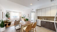 Located at 6775 Golden Gate Dr in Dublin, CA, this 2-bedroom, 2-bathroom residence offers a thoughtfully designed single-level layout that maximizes comfort and functionality. The open-concept kitchen and living area serves as the heart of the home, featuring two-tone cabinetry with crisp white uppers and dark lower cabinets, stainless steel appliances, a tile backsplash, and light wood-style flooring that flows seamlessly throughout. A central kitchen island with a warm wood countertop provides additional prep space and casual seating.

The living room is bright and inviting, bathed in natural light from large windows dressed with sheer curtains. A glass-paneled door leads to a private outdoor area, further enhancing the connection to natural light and fresh air. Both bedrooms are comfortably sized, with the primary bedroom offering a walk-in closet, large windows, and a tranquil, neutral palette. The second bedroom also benefits from natural light and direct closet access. The bathrooms are clean and functional, with one featuring a full tub-shower combination with tiled surround. Two hallways connect the spaces efficiently, and the overall ambiance throughout is warm, modern, and move-in ready.