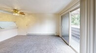 Located at 3815 NE 4th St in Renton, WA, this two-bedroom, one-bathroom unit offers a thoughtfully arranged single-level layout designed to maximize functionality within a cozy footprint. The living area features soft carpeting, neutral cream-toned walls, a ceiling fan, and a baseboard heater. A sliding glass door fills the space with natural light and opens to a private balcony with views of surrounding greenery, creating a pleasant indoor-outdoor connection. The kitchen is efficiently designed with wood-look vinyl flooring, white cabinetry, light countertops, and an electric range with overhead microwave — providing all the essentials in a clean, organized space. Both bedrooms are carpeted and offer a calm, neutral atmosphere; the secondary bedroom includes sliding mirror closet doors and a separate closet for ample storage. The bathroom is appointed with wood-look vinyl flooring, a single vanity with mirror, a combined tub and shower, and overhead lighting. Throughout the unit, the consistent use of light tones and practical finishes creates a clean, move-in-ready environment well-suited for everyday living.