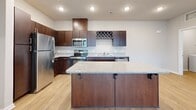 This two-story residence in Granger, IN, offers 1560 square feet of thoughtfully designed living space. The home features three bedrooms, including a generous 190 square foot primary bedroom, and two full bathrooms. The ground floor spans 520 square feet, while the upper level provides 1040 square feet of living area.

The interior boasts an open-concept design, combining the kitchen and living room for a spacious feel. The kitchen is equipped with modern stainless steel appliances, dark wood cabinetry, and a convenient island with a granite countertop. Large windows throughout allow ample natural light, enhancing the bright and airy atmosphere.

Practicality meets comfort with a dedicated laundry room featuring full-sized washer and dryer units. The bathrooms are well-appointed with granite countertops and modern fixtures. Storage solutions include two closets and a utility room.

The home's exterior is part of a well-maintained community with paved roads and ample parking. A garage provides additional storage or vehicle space. The property at Penstemon Pl offers a blend of suburban tranquility and modern convenience, making it an ideal choice for families or professionals seeking a comfortable living environment.