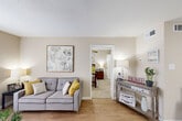 Located at 4800 Lamonte Lane in Houston, TX, this single-floor, one-bedroom, one-bathroom residence offers a thoughtfully organized layout that maximizes every square foot. The living room serves as the welcoming heart of the home, featuring warm wood-look flooring, neutral beige walls, and a large window dressed with sheer curtains that invite natural light to fill the space. The galley-style kitchen is efficiently designed with dark cabinetry, white tile backsplash, light countertops, and black appliances including a range and refrigerator. A peninsula counter with seating connects the kitchen to the adjacent dining area, creating a functional flow for everyday living. The bedroom offers plush carpeting, a ceiling fan with light fixture, and a sliding glass door that allows additional natural light into the room. A dedicated closet provides organized storage space. The bathroom features a clean, white tiled tub-shower combination. Throughout the residence, the warm, neutral color palette and consistent design choices create a cohesive and comfortable ambiance suited for efficient, single-story living in the heart of Houston.