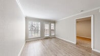 Located at 450 El Dorado Blvd in Houston, TX, this one-bedroom, one-bathroom unit offers a thoughtfully arranged single-floor layout that maximizes every square foot. The entrance welcomes you through a charming glass-paned door that fills the foyer with natural light. The combined kitchen and living area serves as the heart of the home, featuring light hardwood-style flooring, neutral gray walls, and crown molding that adds a refined touch. Large windows and a glass exterior door flood the living space with abundant natural light while offering views of the surrounding greenery. The kitchen is equipped with stainless steel appliances, including a refrigerator and range, complemented by white cabinetry and granite-style countertops. The bedroom is a comfortable retreat with plush carpeting, a ceiling fan with light fixture, and a window with exterior views. A dedicated closet provides convenient storage. The full bathroom features a tiled tub-shower combination, wood-style flooring, and clean white finishes throughout. The unit's cohesive neutral palette and consistent finishes create a bright, welcoming ambiance from room to room.