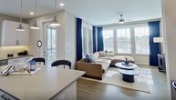 This well-appointed 990-square-foot apartment at 2300 Hooks St, Unit 1210, in Clermont, FL features 2 bedrooms, 2 bathrooms, and a thoughtfully designed single-floor layout. The sun-filled living room is a standout, with large windows dressed in bold blue drapes, wood-look flooring, and a ceiling fan, creating a bright and inviting atmosphere. The modern kitchen is equipped with white shaker cabinets, quartz countertops, stainless steel appliances, a subway tile backsplash, a large center island with bar seating, and pendant lighting. The primary bedroom spans 160 square feet and includes a ceiling fan, generous natural light, and access to a walk-in closet featuring built-in shelving, hanging rods, and basket storage. The en-suite primary bathroom offers a sleek glass-enclosed walk-in shower. The second bedroom is equally bright, with large windows and a ceiling fan. The second bathroom includes a soaking tub with a tiled surround and built-in niche. Wood-look flooring runs throughout the unit, tying together the clean, contemporary aesthetic of this comfortable Clermont residence.