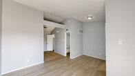 Located at 7760 McCallum Blvd in Dallas, TX, this one-bedroom, one-bathroom unit offers a well-organized layout across a single floor. The combined living and dining area greets you upon entry, featuring light wood-look flooring, soft gray walls, a textured ceiling, and a front door flanked by large windows that flood the space with natural light. A sliding glass door leads directly to a private balcony, extending the living space outdoors. The kitchen is efficiently designed with white cabinetry, light stone-finish countertops, stainless steel appliances including a refrigerator and dishwasher, and a window with blinds that brings in additional natural light. The bedroom is carpeted and equipped with a ceiling fan, vaulted-style ceiling, and access to a dedicated closet, offering a comfortable and functional retreat. The bathroom features a full tub-shower combination with white tile surround. Additional conveniences include an in-unit laundry area, providing practical day-to-day functionality. Throughout the unit, a consistent cool gray color palette and clean finishes create a cohesive, neutral aesthetic well-suited to a variety of furnishing styles.