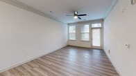 This 720 square foot apartment in Concord, NC, offers a thoughtful blend of comfort and functionality. The single-floor layout maximizes space efficiency, featuring one bedroom and one bathroom. The heart of the home is an open-concept living area, showcasing wood-look vinyl flooring that extends throughout most of the space, creating a seamless and contemporary aesthetic.

The kitchen is a highlight, boasting sleek white cabinetry, stainless steel appliances, and a stylish mosaic tile backsplash. Granite countertops add a touch of elegance, while pendant lighting enhances the modern ambiance. The living room, connected to the kitchen, offers ample natural light through large windows and access to an outdoor space via a glass door.

The bedroom, measuring 190 square feet, features plush carpeting and is equipped with a ceiling fan for comfort. Large windows ensure the room is bright and airy. The bathroom is designed with accessibility in mind, featuring a tub with multiple grab bars and a handheld showerhead.

Throughout the apartment, crown molding adds a refined touch, while recessed lighting and ceiling fans contribute to the overall modern feel. The neutral color palette allows for easy personalization, making this space an ideal canvas for various design styles.