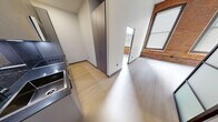 Located at 30 Laurel St in Hartford, CT, this thoughtfully designed 3-bedroom, 1-bathroom unit masterfully combines industrial heritage with modern aesthetics. Throughout the space, light-toned luxury vinyl flooring provides a clean, cohesive foundation that complements the overall design.

The generously sized primary bedroom impresses with soaring ceilings accented by exposed dark wood beams and ample built-in cabinetry finished in warm taupe tones. Distinctive steel-framed frosted glass doors add an elegant, loft-inspired touch while allowing natural light to filter through. A wall-mounted mini-split system ensures year-round comfort.

The two additional bedrooms showcase stunning exposed brick walls framing large windows that allow abundant natural light to pour in, highlighting the building's original character. The brick's rich, warm tones create a striking contrast against the crisp white walls.

The bathroom is a standout feature, offering a spa-like experience with a freestanding soaking tub, a frameless glass-enclosed walk-in shower with designer fixtures, a floating vanity, and sophisticated tile work throughout.

The kitchen is equipped with stainless steel appliances and modern grey cabinetry, completing this unit's seamless blend of historic charm and contemporary living.