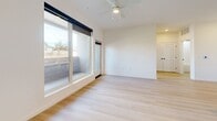 Located at 9330 Eagle Ranch Rd NW in Albuquerque, New Mexico, this two-bedroom, two-bathroom residence offers a thoughtfully designed single-floor layout with modern finishes throughout. Light wood-style flooring flows seamlessly across the entire space, creating a bright and cohesive aesthetic.

The open-concept living, dining, and kitchen area serves as the heart of the home. The kitchen is outfitted with stainless steel appliances — including a French door refrigerator, electric range, microwave, and dishwasher — complemented by two-tone cabinetry featuring dark lower cabinets and natural wood upper cabinets, white tile backsplash, and a grey quartz peninsula with an undermount sink and matte black faucet. A ceiling fan and large windows with direct patio access fill the living area with natural light and outdoor views.

Both bedrooms are generously windowed, inviting abundant natural light and neighborhood views. The primary bedroom includes a ceiling fan and access to the patio. Three closets provide ample storage throughout the unit. Each bathroom features a soaking tub/shower combination with white subway tile surround and striking matte black fixtures. Additional conveniences include an in-unit laundry area and a private outdoor patio.