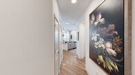 This single-story residence at 3171 US-280 in Birmingham, Alabama, offers a thoughtfully designed layout with contemporary finishes and a cohesive aesthetic throughout. A welcoming entryway hallway, accented by decorative wall art, leads into the heart of the home, where wood-look flooring flows seamlessly underfoot.

The kitchen is a standout feature, equipped with stainless steel appliances, gray shaker-style cabinetry, dark granite countertops, and a generous island with seating for multiple guests. Cone-shaped glass pendant lights hang above the island, adding a modern touch. Ample storage and prep space make this kitchen as functional as it is visually appealing.

The living area is bright and open, benefiting from multiple windows that allow generous natural light to fill the space. A ceiling fan adds comfort, while the layout easily accommodates both lounging and dining areas.

The bedrooms are serene and well-proportioned, each featuring wood-look flooring, ceiling fans, and windows with outdoor views. The primary suite includes a walk-in closet with built-in shelving and a private bathroom with granite counters, a single-sink vanity, and a tiled tub-shower combination.
