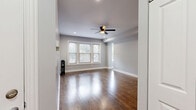 Located at 1222 W Rosemont Ave in Chicago's Edgewater neighborhood, this well-appointed 3-bedroom, 1-bathroom unit offers a thoughtfully designed single-floor layout. Rich, dark hardwood floors run throughout the home, complementing the neutral gray walls and bright white trim for a clean, modern aesthetic.

The living room is generously sized, featuring a ceiling fan, recessed lighting, and a bank of windows that flood the space with natural light. A classic cast-iron radiator adds a charming nod to the building's history. Each of the three bedrooms continues the hardwood flooring and radiator motif, with windows providing natural light and views of the surrounding neighborhood. One bedroom includes a built-in shelving nook, offering convenient storage.

The kitchen is well-equipped with two-tone cabinetry — white upper shaker-style cabinets paired with gray lower cabinets — white subway tile backsplash, light quartz countertops, and a full suite of stainless steel appliances including a refrigerator, range, and microwave. The bathroom features a sliding glass walk-in shower, a gray vanity with white countertop, and light tile flooring. Five closets are distributed throughout the unit, providing ample storage. A connecting hallway ties all rooms together efficiently.