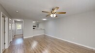 Located at 60 Jane Ln in Newnan, Georgia, this 1-bedroom, 1-bathroom residence offers a practical and well-designed single-floor layout. The open-concept living and kitchen area is finished with warm-toned luxury vinyl plank flooring and neutral gray walls, creating a bright, cohesive atmosphere. A ceiling fan with a light kit is centrally positioned in the living area, providing both comfort and illumination, while a textured ceiling adds a classic touch.

The kitchen is a standout feature, boasting gray shaker-style cabinetry, a white subway tile backsplash, stainless steel appliances including a refrigerator, microwave, and range, and a clean white countertop that extends into a breakfast bar — ideal for casual dining.

The spacious bedroom is carpeted for comfort and includes a ceiling fan, natural light from a window with blinds, and direct access to a generously sized walk-in closet outfitted with multi-tiered wire shelving for ample storage.

The bathroom is clean and functional, featuring hardwood-style flooring, a white vanity, and a full soaking tub with a shower curtain rod. Throughout the residence, soft neutral tones and consistent finishes create a calm, move-in-ready environment.
