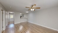 Located at 60 Jane Ln in Newnan, Georgia, this 1-bedroom, 1-bathroom residence offers a practical and well-designed single-floor layout. The open-concept living and kitchen area is finished with warm-toned luxury vinyl plank flooring and neutral gray walls, creating a bright, cohesive atmosphere. A ceiling fan with a light kit is centrally positioned in the living area, providing both comfort and illumination, while a textured ceiling adds a classic touch.

The kitchen is a standout feature, boasting gray shaker-style cabinetry, a white subway tile backsplash, stainless steel appliances including a refrigerator, microwave, and range, and a clean white countertop that extends into a breakfast bar — ideal for casual dining.

The spacious bedroom is carpeted for comfort and includes a ceiling fan, natural light from a window with blinds, and direct access to a generously sized walk-in closet outfitted with multi-tiered wire shelving for ample storage.

The bathroom is clean and functional, featuring hardwood-style flooring, a white vanity, and a full soaking tub with a shower curtain rod. Throughout the residence, soft neutral tones and consistent finishes create a calm, move-in-ready environment.