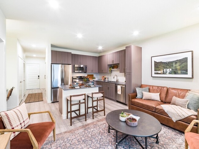 An open-concept apartment home at Modera University Park, where kitchen, dining, and living spaces come together for effortless everyday living. - Modera University Park Apartments