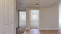This single-floor, 2-bedroom, 1-bathroom home features a thoughtfully organized layout that maximizes every square foot of its comfortable living space. The interior is finished throughout in soft, warm cream tones that create a bright and welcoming ambiance.

The kitchen is well-equipped with rich cherry wood cabinetry, granite-style countertops, and a full suite of stainless steel appliances, including a refrigerator, electric range, and dishwasher. Light tile flooring extends through the kitchen and hallway areas, providing a clean and durable surface in the main traffic zones.

Both bedrooms are carpeted and finished with crown molding, ceiling fans, and natural light from windows fitted with blinds. The primary bedroom offers a generous footprint with a double-door closet, providing ample storage. The second bedroom is equally well-appointed with its own ceiling fan and closet access.

The bathroom is clean and functional, featuring tile flooring, a full soaking tub with a shower, a wood-toned vanity with granite-style countertops, and a wall-mounted towel bar.

A central hallway connects all rooms efficiently, contributing to the home's practical and comfortable flow. The consistent finishes and neutral palette throughout make this a move-in ready space with broad appeal.