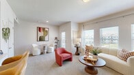 Located at 8800 N Ames Dr in Kansas City, MO, this two-bedroom, two-bathroom residence offers a thoughtfully designed single-floor layout that maximizes comfort and functionality. The open-concept living area is bright and inviting, featuring large windows that flood the carpeted space with natural light and offer views of the surrounding neighborhood. A built-in fireplace and a pass-through kitchen bar with seating add to the living room's welcoming atmosphere.

The kitchen is well-equipped with crisp white shaker cabinetry extending to the ceiling, white quartz countertops, a classic subway tile backsplash, and stainless steel appliances including a range, microwave, and refrigerator. A pantry provides additional storage convenience.

The generously sized primary bedroom features a ceiling fan, large windows with exterior views, and access to a dedicated closet. The second bedroom is equally comfortable, also with a ceiling fan and ample natural light. Both bathrooms are clean and functional, with one featuring a tiled tub-shower combo, wood-look flooring, and white cabinetry.

Additional highlights include a dedicated laundry area and a neutral, warm color palette throughout that gives the entire residence a cohesive and modern feel.