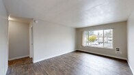 This well-organized one-bedroom, one-bathroom unit is thoughtfully laid out across a single floor, offering a functional and comfortable living environment. The living room is a bright, open space featuring rich wood-style flooring and a large window that fills the room with natural light while providing views of the surrounding greenery. A ceiling fan overhead adds both style and practicality to the area. The dining and kitchen area flows seamlessly from the living space, showcasing white cabinetry, a full-size refrigerator, a sink, and ample counter space — all finished with the same warm wood-style flooring for a cohesive look. The bedroom is a comfortable retreat with soft carpeting underfoot, a window allowing in natural light, and access to multiple closets, providing generous storage options. Three closets in total ensure practical organization throughout the unit. The bathroom is clean and efficient, featuring a full tub-shower combination, a vanity with counter space, and wood-style flooring. Neutral tones throughout the unit create a calm, versatile backdrop suited to a variety of décor styles. Baseboard heating is present in key areas, ensuring comfort year-round.