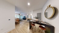 Located at 1105 Sunset Crest Lane in Summerville, SC, this single-story 2-bedroom, 2-bathroom home offers a thoughtfully designed open-concept layout with modern finishes throughout. Light wood-style flooring flows seamlessly across the main living areas, creating a bright and cohesive feel.

The kitchen features white cabinetry with gold hardware, stainless steel appliances, subway tile backsplighting, and a built-in wine rack. It opens directly to the dining area, which is anchored by pendant lighting and a stylish bar-height table. The adjacent living room is highlighted by a textured accent wall, a ceiling fan, and generous natural light from multiple windows with patio door access.

The primary bedroom is a spacious retreat with a patterned accent wall, ceiling fan, and large windows dressed in sheer curtains. The second bedroom offers a warm, earthy ambiance with a bold accent wall and ample natural light. Both rooms are well-proportioned and comfortable.

The primary bathroom includes a dual-sink vanity with gold fixtures, gray countertops, white cabinetry, and a walk-in shower. The second bathroom features a full soaking tub with marble-style tile surround. A hallway and closet complete the functional layout of this stylishly finished Summerville home.