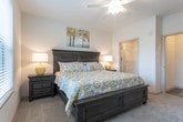 This single-story residence in Cumming, GA, offers a thoughtfully designed layout with a cohesive blend of modern finishes and functional living spaces throughout. The living room is bright and inviting, featuring large windows fitted with horizontal blinds that allow ample natural light, crown molding, and neutral walls that complement a range of décor styles.

The galley-style kitchen is well-equipped, showcasing white shaker cabinetry with black hardware, granite countertops, wood-look flooring, and a full suite of stainless steel appliances, including a range, microwave, refrigerator, and dishwasher. An adjacent dining area features wood-look flooring, crown molding, and a statement lantern-style chandelier overhead.

The bedrooms are carpeted and comfortable, each offering neutral tones and natural light from well-placed windows with outdoor views of greenery. The bathrooms are finished with granite-topped white vanities, wood-look flooring, and tub-shower combinations with curved curtain rods. A dedicated laundry area houses a full-size washer and dryer with overhead wire shelving for added storage. Overall, the space maintains a clean, contemporary aesthetic throughout.