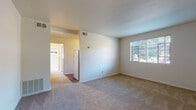 Located at 1750 Clifton Ave. in Columbus, Ohio, this single-floor unit offers a straightforward and functional layout spread across several connected rooms. The living area is finished with neutral carpet and bright white walls, creating a clean, open atmosphere. Multiple windows fitted with horizontal blinds allow natural light to filter throughout, offering views of the surrounding greenery. A entry area features dark hardwood-style flooring that transitions into the carpeted main living space, providing a clear delineation between zones.

The bedroom is well-proportioned, featuring carpet flooring and dual windows equipped with a window air conditioning unit, ensuring comfortable ventilation. The layout, as seen in the 3D floor plan, illustrates a compact but efficient arrangement of rooms connected by a central corridor.

The kitchen is equipped with warm honey-toned wood cabinetry both above and below granite-style laminate countertops, a stainless steel sink, and a white gas range, offering a practical cooking environment.

The bathroom showcases classic tilework with white subway tiles accented by bold navy blue border tiles. The floor features a traditional black-and-white mosaic tile pattern, complementing the full-sized soaking tub and pedestal sink. A frosted window provides natural light while maintaining privacy.