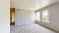 Located at 4500 Campus Dr in Fort Worth, TX, this three-bedroom, one-bathroom unit offers a practical and efficiently organized single-floor layout. The space features neutral-toned walls throughout, paired with plush wall-to-wall carpeting in all bedrooms, creating a consistent and comfortable atmosphere. The generously sized primary bedroom is a standout feature, offering ample room and a walk-in closet for storage, along with an additional door providing convenient access to the shared bathroom. Two additional bedrooms each receive natural light through windows with exterior views, making them well-suited for sleeping quarters, a home office, or guest use. A second closet provides further storage options within the unit. The galley-style kitchen is thoughtfully arranged with white cabinetry lining both sides, light countertops with a tile backsplash, and wood-look vinyl flooring. Black appliances including a range and dishwasher complete the kitchen's functional setup. The full bathroom features a tiled tub-shower combination, a vanity with storage, and wood-look flooring that coordinates with the kitchen. A ceiling fan is installed in the living area, adding to the unit's practical amenities. Overall, the space presents a clean, functional design well-suited for everyday living.