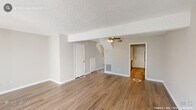 Located at 3908 Paddington Ct in Raleigh, NC, this two-story home offers 2 bedrooms and 4 bathrooms across two well-proportioned floors. The main level features a spacious living room with rich hardwood-style flooring, a ceiling fan, and a textured ceiling. Sliding glass doors flood the space with natural light and open to a private deck with serene tree-lined views. The adjacent galley kitchen is thoughtfully appointed with white shaker cabinetry, light granite countertops, a classic subway tile backsplash, black appliances including an electric range and dishwasher, and track lighting overhead. The upper level hosts both bedrooms, each carpeted and bathed in natural light. The generously sized primary bedroom features dual closets and a ceiling fan, providing ample storage and comfort. A dedicated walk-in closet adds further convenience. The four bathrooms include vanities with granite-style countertops and clean white fixtures, with at least one featuring a vaulted ceiling detail that adds architectural interest. Neutral tones throughout create a cohesive and inviting ambiance, while hallways on both floors ensure smooth flow between spaces.