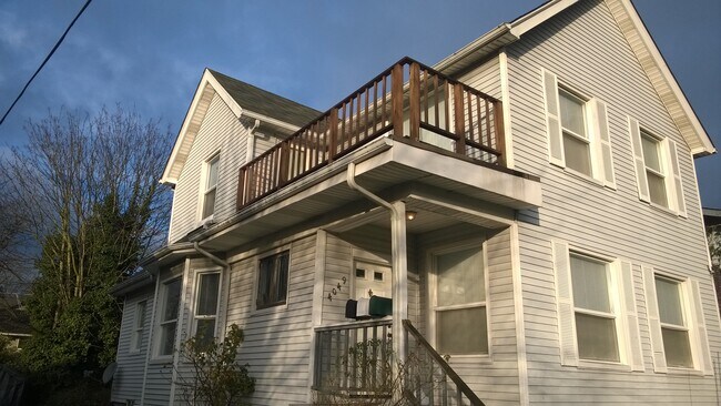 Exterior view of upper unit prior to newly painted deck - 4049 Latona Avenue NE Apartments