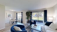 Located at 803 Don Quixote Ave in Orlando, FL, this single-floor, 2-bedroom, 2-bathroom home offers a well-organized layout designed for comfortable everyday living. The open-concept living and dining area serves as the heart of the home, filled with natural light streaming through large sliding glass doors that frame views of a verdant outdoor green space. The living room features wood-style flooring, a textured ceiling, and ample room for relaxed seating arrangements. The adjacent dining area benefits from its own window, further enhancing the bright, airy atmosphere throughout the shared space. The kitchen is efficiently designed with white cabinetry, light granite-style countertops, and a full suite of white appliances including a range, dishwasher, and refrigerator. Both bedrooms are well-proportioned, with the primary bedroom offering natural light through a window with draping curtains and wood-style flooring. Three closets provide generous storage throughout the home. The two bathrooms are clean and functional, each featuring a shower-tub combination. Two hallways connect the private and shared areas of the home smoothly. This residence offers a practical and comfortable layout in a convenient Orlando location.