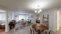 This single-floor unit at 1545 15th Ave SE in Saint Cloud, Minnesota, offers a well-organized layout connecting living, dining, and sleeping spaces in a cohesive flow. The open-concept living and dining area is anchored by light wood-style flooring, a textured ceiling, and a stylish chandelier above the dining space. Large windows and a exterior door flood the living area with natural light while providing pleasant views of mature trees and green outdoor surroundings.

The kitchen features white shaker-style cabinetry, dark countertops, a subway tile backsplash, and black and stainless steel appliances, including a range, microwave, refrigerator, and dishwasher, all set on light wood-style flooring.

Multiple bedrooms offer carpeted floors, textured ceilings, and windows with outdoor views, creating comfortable, naturally lit retreats. The bathrooms are finished with white cabinetry, light wood-style flooring, and clean, neutral tones—one featuring a tub-shower combination and another with a vanity area. Throughout the unit, a neutral color palette and consistent finishes contribute to a cohesive and functional living environment.