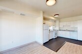 Located at 2905 Santa Rosa Ave in Santa Rosa, CA, this single-floor, 3-bedroom, 2-bathroom residence offers a practical and well-organized layout. The open-concept living, dining, and kitchen area forms the heart of the home, featuring light wood-style flooring that transitions seamlessly into the kitchen's durable dark vinyl flooring. The kitchen is equipped with ample white cabinetry, granite-style countertops, a full-size refrigerator, and a range with overhead ventilation, providing generous storage and prep space. Natural light flows in through large windows and a glass-panel door leading to a private balcony, offering outdoor views of the surrounding neighborhood. The three bedrooms are carpeted for comfort, with the generously sized primary bedroom offering notable square footage. Four closets throughout the unit provide abundant storage, including walk-in style closets with wire shelving systems. Both bathrooms feature light vinyl flooring, a tub-shower combination with tiled surrounds, pedestal sinks, wall-mounted storage cabinets, and a clean, bright aesthetic. A hallway connects the bedrooms and bathrooms, contributing to an efficient and cohesive floor plan throughout the home.