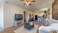 Located at 2500 Bellerive Ave in Bryant, Arkansas, this single-floor, three-bedroom, two-bathroom residence offers a well-organized and functional layout. The open-concept living and kitchen area serves as the heart of the home, where soft carpet flows through the living space and transitions to durable wood-look flooring in the kitchen. The living room benefits from abundant natural light through multiple windows and features a ceiling fan overhead. The kitchen is outfitted with white cabinetry, dark countertops, black appliances including a range, microwave, and refrigerator, and a peninsula with bar seating — ideal for casual dining or entertaining. A dedicated dining area sits adjacent to the kitchen. The generously sized primary bedroom includes a ceiling fan, closet, and plush carpet, offering a comfortable retreat. The two additional bedrooms are well-proportioned, each with closet access, carpet, and natural light from exterior windows. Both bathrooms feature wood-look flooring, a tub-shower combination with sliding glass doors, and clean, neutral finishes. A laundry room and hallway with additional closet storage round out the practical layout of this efficiently designed residence.