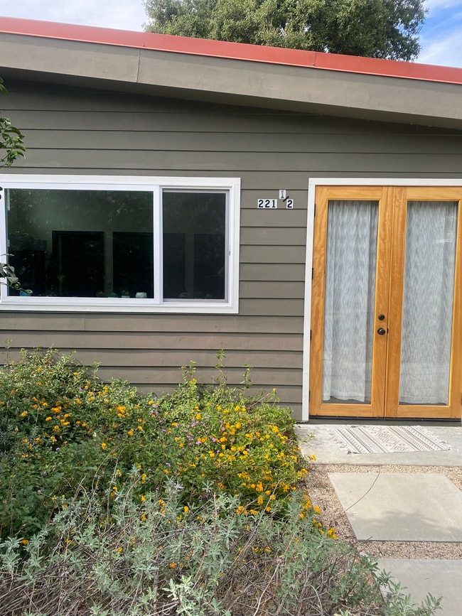 French doors open onto a large grapefruit tree and a small patio for al fresco dining - 221 Wapello St