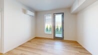 Located in Liberty Lake, WA, this thoughtfully designed 2-bedroom, 2-bathroom residence offers a clean, modern aesthetic throughout its well-organized single-floor layout. Light wood flooring flows seamlessly through every room, creating a warm and cohesive feel.

The kitchen is a standout feature, equipped with stainless steel appliances including a gas range, built-in microwave, refrigerator, and dishwasher. Two-toned cabinetry in soft blue-gray and white pairs with bright white countertops and a classic subway tile backsplash, all illuminated by recessed lighting.

Each bedroom is bright and comfortable, with large windows fitted with horizontal blinds that invite natural light and outdoor views of surrounding greenery. Both bedrooms are equipped with wall-mounted mini-split units for individual climate control. The primary bedroom benefits from direct outdoor access via a glass-panel door, along with a dedicated closet and an en-suite bathroom.

Both bathrooms are finished with clean, white fixtures, full tub-shower combinations with chrome hardware, and durable wood-look flooring. Additional closet space supports practical storage needs throughout the unit. The overall design is modern, minimal, and move-in ready.