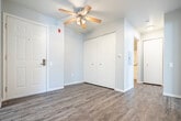 Located at 902 N High Point Rd in Madison, WI, this single-floor 3-bedroom, 1-bathroom unit offers a practical and well-organized layout. The galley-style kitchen is efficiently designed with white cabinetry, gray laminate countertops, stainless steel appliances including a refrigerator, electric range, microwave, and dishwasher, and durable wood-look flooring. A pass-through window connects the kitchen to the living room, enhancing the open feel between spaces. The living room is carpeted and filled with natural light, featuring a sliding glass door that opens to a private balcony with outdoor views. Baseboard heating runs throughout the unit, and a wall air conditioning unit is present in the living area. The three bedrooms are carpeted and finished in neutral tones, each offering a quiet and functional space. The primary bedroom includes its own closet. The full bathroom is appointed with a white vanity, light countertop, wood-look flooring, a large mirror, and a well-lit vanity fixture. A hallway connects the main living areas to the bedrooms, with additional closet storage accessible along the way. The unit's clean, neutral palette and functional design make it a versatile and comfortable space.