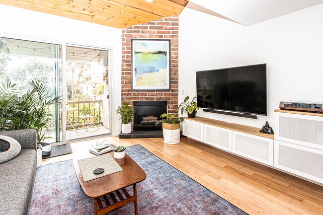 bright & airy living room with gas fireplace & floating media console - 8740 Tuscany Ave