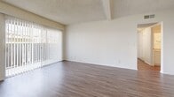 Located in Brea, CA, this single-story 2-bedroom, 3-bathroom home offers a practical and well-organized floor plan. The open-concept living, dining, and kitchen area serves as the heart of the home, featuring wood-look laminate flooring, textured ceilings with exposed beams, and a sliding glass door with vertical blinds that floods the space with natural light and opens to a private patio. A ceiling fan in the dining area adds comfort and airflow.

The galley-style kitchen is efficiently designed with ample white cabinetry, granite-look countertops, a double sink, dishwasher, and electric range. A dedicated pantry provides additional storage. A pass-through window connects the kitchen to the living area, maintaining an open feel.

Both bedrooms are carpeted and bright, with vertical blinds on the windows. The spacious primary bedroom includes direct access to an en-suite bathroom with a wide vanity featuring granite-look counters, a large mirror, and wood-look flooring. The bathrooms are clean and functional — one features a tub/shower combo and another a walk-in shower with sliding glass doors. Three closets throughout the home offer generous storage. The neutral palette and consistent finishes create a cohesive, move-in-ready atmosphere.