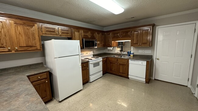 Kitchen amenities include stove, new microwave, new disposal, dishwasher, and refrigerator. - 1211 Goldridge Dr SW