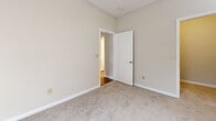 Located at 761 Rice Rd in Ridgeland, Mississippi, this single-floor, one-bedroom, one-bathroom residence offers a well-organized and functional layout across a compact but efficient footprint. The living room is a bright, open space featuring warm wood-look laminate flooring, a ceiling fan, and a pair of French doors with blinds that invite natural light and provide access to the outdoors. Adjacent to the living area, the kitchen is equipped with stainless steel appliances — including a smooth-top range, over-the-range microwave, and a French door refrigerator — complemented by contemporary flat-front cabinetry in a warm wood tone and a clean light-colored countertop with a subtle tile backsplash. The bedroom is a comfortably sized room with plush wall-to-wall carpeting, a ceiling fan, a window with blinds, and its own dedicated closet featuring wire shelving for organized storage. The bathroom includes a full tub/shower combination with white tile surround, a wood-toned vanity with a light countertop, and hardwood-style flooring. A separate laundry area with hardwood-style flooring rounds out the home. Neutral wall tones and white trim throughout lend the space a clean, cohesive aesthetic.