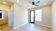 Located at 7319 Nordling Rd in Houston, TX, this single-story, one-bedroom, one-bathroom unit offers a thoughtfully designed layout with modern finishes throughout. Light wood-style flooring extends seamlessly across all rooms, creating a bright and cohesive aesthetic.

The kitchen is a standout feature, outfitted with crisp white shaker cabinets with matte black hardware, light quartz countertops, a single-basin sink with a black faucet, and a full suite of stainless steel appliances including a refrigerator, electric range, microwave, and dishwasher. Recessed lighting and a ceiling vent ensure the space remains well-lit and comfortable.

The bedroom is a comfortable, well-proportioned room featuring neutral walls, natural light from dual windows, and a ceiling fan. The clean, minimalist design makes the space versatile and inviting.

The bathroom is well-appointed, showcasing a dual-sink white vanity with ample drawer storage, matte black fixtures, and a combined tub and shower enclosed with elegant marble-patterned tile surround and glass panels. A doorway from the bathroom leads directly into a dedicated walk-in closet with a built-in shelving and rod system.

A hallway connects the living areas efficiently, and the open-concept flow between the kitchen and main living space maximizes functionality throughout this well-designed Houston residence.