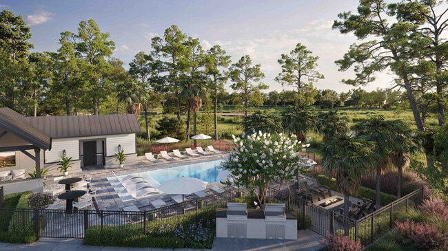 An outdoor oasis, the pool amenity at Fenland Townhomes overlooks the marsh and offers a sun ledge, covered pavilion, grilling area, and a cozy fire pit. - Fenland Townhomes