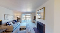 Located at 265 Camelback Rd in Pleasant Hill, California, this single-story unit offers a thoughtfully designed layout that balances comfort and functionality. The living room serves as the centerpiece of the home, featuring plush carpeting, a textured ceiling, and a striking tile-surround fireplace as a focal point. Large sliding glass doors flood the space with natural light and open directly onto a private balcony, providing pleasant outdoor views. A gold-framed mirror accents the wall, adding a decorative touch to the bright, neutral interior.

The open-concept design connects the living area seamlessly to a dedicated dining space and kitchen. The kitchen is well-equipped with warm wood cabinetry, granite-style countertops, a double-basin stainless steel sink, and white appliances, including a range and dishwasher. Light hardwood-style flooring runs through the kitchen and dining area, complementing the overall aesthetic.

Both bedrooms are carpeted and feature neutral walls with ample natural light from large windows or sliding glass doors leading to additional balcony access. The two bathrooms are finished with wood cabinetry, granite-style countertops, and light flooring—one includes a tub/shower combo and the other offers a separate water closet configuration.